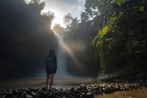 Girl looking at Tegenungan Waterfall